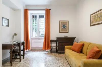 a living room with a couch and a desk and a window at Angels Beauty House in Rome