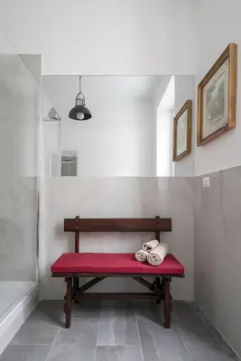 a bench with a red cushion in a room at Angels Beauty House in Rome