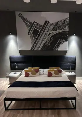 a bedroom with a bed with a painting on the wall at Domus Angel's of Rome in Rome