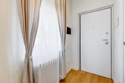 a room with a door and a curtain and a mirror at Vivilo Collection - Loft Santo Spirito in Rome