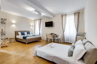 a bedroom with a bed and a table in a room at Vivilo Collection - Loft Santo Spirito in Rome