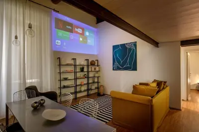 a living room with a table and a couch at Liberti Colosseo - Luxury Apartment in Rome