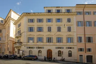 a large building with motorcycles parked in front of it at Liberti Colosseo - Luxury Apartment in Rome