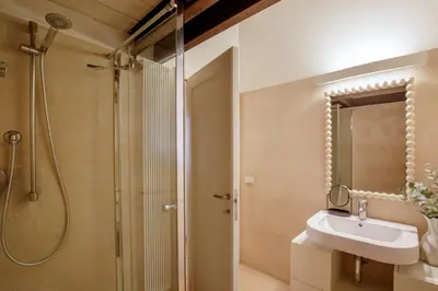 a bathroom with a sink and a shower at Liberti Colosseo - Luxury Apartment in Rome