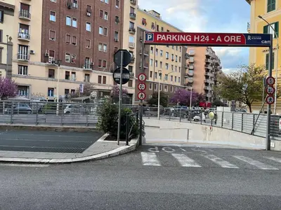a street sign on a city street with buildings at Aldo in Rome