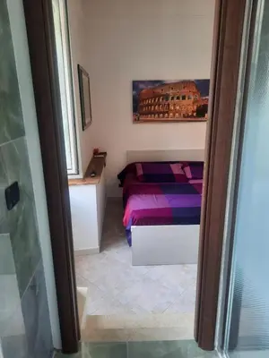 a small bedroom with a bed and a window at Aldo in Rome