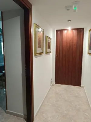a hallway with a wooden door and a mirror at Aldo in Rome
