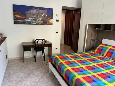 a bedroom with a bed and a desk and a table at Aldo in Rome