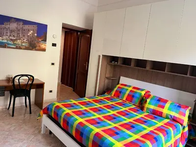 a bedroom with a bed with a colorful blanket at Aldo in Rome