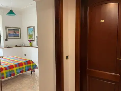 a room with a bed and a wooden door at Aldo in Rome