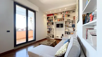 a living room with a white couch and a window at La Casa di Livietta in Rome
