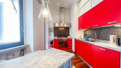 a kitchen with red cabinets and a counter top at La Casa di Livietta in Rome
