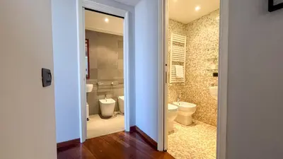 a bathroom with two toilets and a shower at La Casa di Livietta in Rome