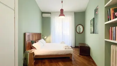 a bedroom with a bed in a room with green walls at La Casa di Livietta in Rome