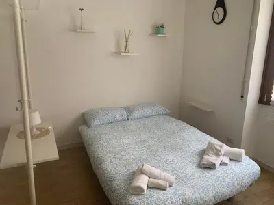a bedroom with a bed with towels on it at Cozy Piramide Rooms in Rome