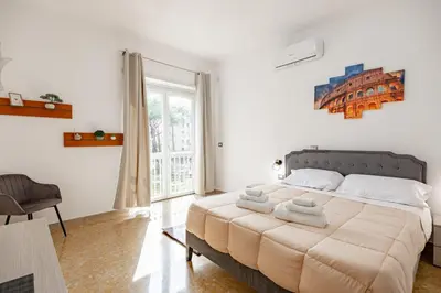a bedroom with a large bed and a window at La Dolce Vita in Rome