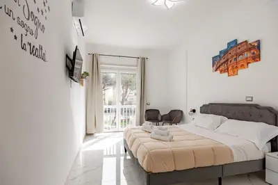 a bedroom with a large bed in a white room at La Dolce Vita in Rome