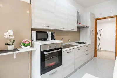 a kitchen with white cabinets and a microwave at La Dolce Vita in Rome
