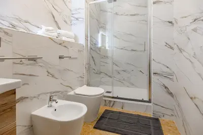 a bathroom with a toilet sink and a shower at La Dolce Vita in Rome
