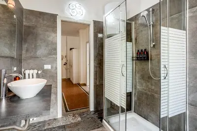 a bathroom with a shower and a sink and a tub at Amor Rome Apartment & Suites in Rome
