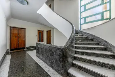 a spiral staircase in a building with a window at Amor Rome Apartment & Suites in Rome