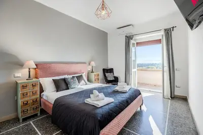 a bedroom with a large bed and a large window at Amor Rome Apartment & Suites in Rome