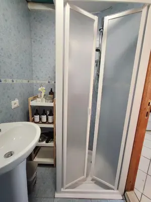 a shower stall in a bathroom with a sink at Easy Suite Roma San Pietro in Rome