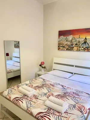 a bedroom with a large bed with towels on it at Easy Suite Roma San Pietro in Rome