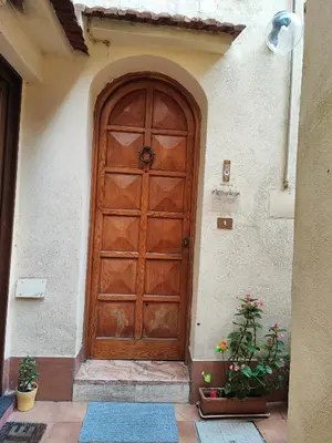 a wooden door on the side of a building at Easy Suite Roma San Pietro in Rome