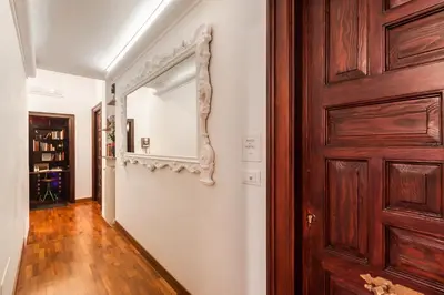 a hallway with a door and a wooden floor at Residenza Romana in Rome
