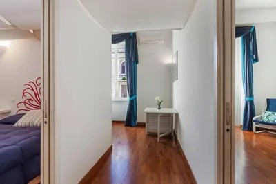 a bedroom with a blue bed and a mirror at Residenza Romana in Rome