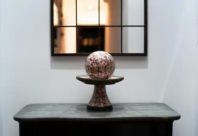 a vase sitting on a table in front of a wall at Residenza Romana in Rome