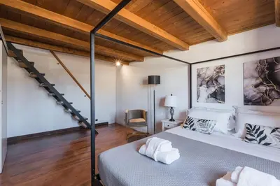 a bedroom with a large bed and a wooden ceiling at Vatican Duplex, perfect for visiting Rome in Rome