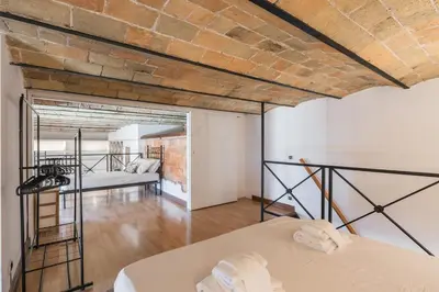 a room with two beds and a brick wall at Vatican Duplex, perfect for visiting Rome in Rome