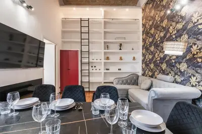 a dining room with a table and chairs and a couch at Vatican Duplex, perfect for visiting Rome in Rome