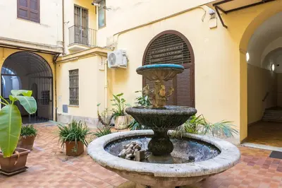 a fountain in the courtyard of a building at Vatican Duplex, perfect for visiting Rome in Rome