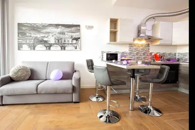 a living room with a couch and a table at Stylish suite close by Trastevere and city life in Rome