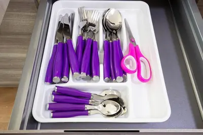 a tray filled with utensils and purple scissors at Stylish suite close by Trastevere and city life in Rome