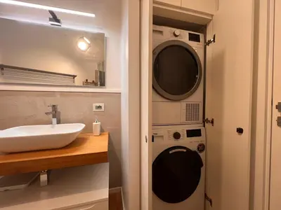 a bathroom with a washing machine and a sink at San Giovanni tourist accommodation in Rome