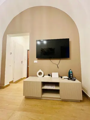 a living room with a tv on a wall at Luminosa House Roma Central Station in Rome