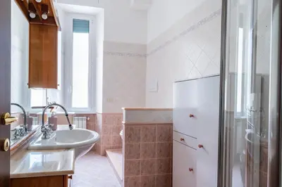 a bathroom with a sink and a white refrigerator at Grandma Roma San Giovanni in Rome