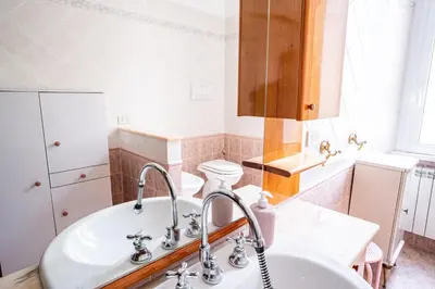 a bathroom with a sink and a white sink at Grandma Roma San Giovanni in Rome