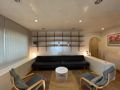 a living room with a black couch and chairs at Giulio Cesare APT in Rome