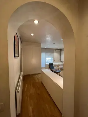an archway in a living room with a couch and a kitchen at Giulio Cesare APT in Rome