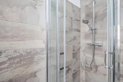 a shower with a glass door in a bathroom at Gens Iulia 2 Min da Stazione Trastevere by Hôtea in Rome
