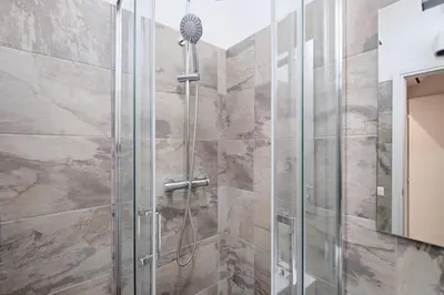 a shower with a glass door in a bathroom at Gens Iulia 2 Min da Stazione Trastevere by Hôtea in Rome