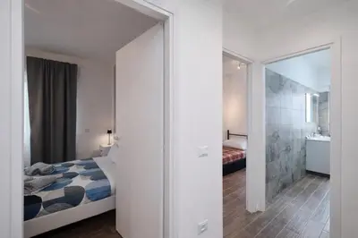 a bedroom with a bed and a walk in closet at Gens Iulia 2 Min da Stazione Trastevere by Hôtea in Rome