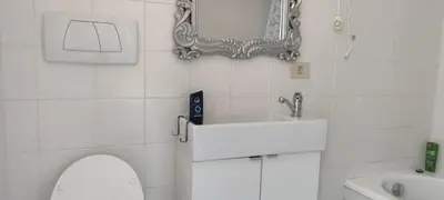 a bathroom with a sink and a toilet and a mirror at corte degli ulivi in roma in Rome