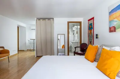 a bedroom with a large white bed with yellow pillows at Romantic Refuge in Piazza Navona in Rome