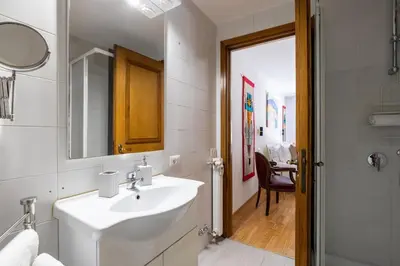 a white bathroom with a sink and a mirror at Romantic Refuge in Piazza Navona in Rome